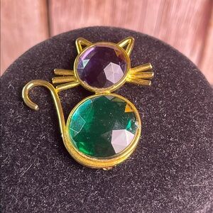Gold cat brooch with purple & green gem stones